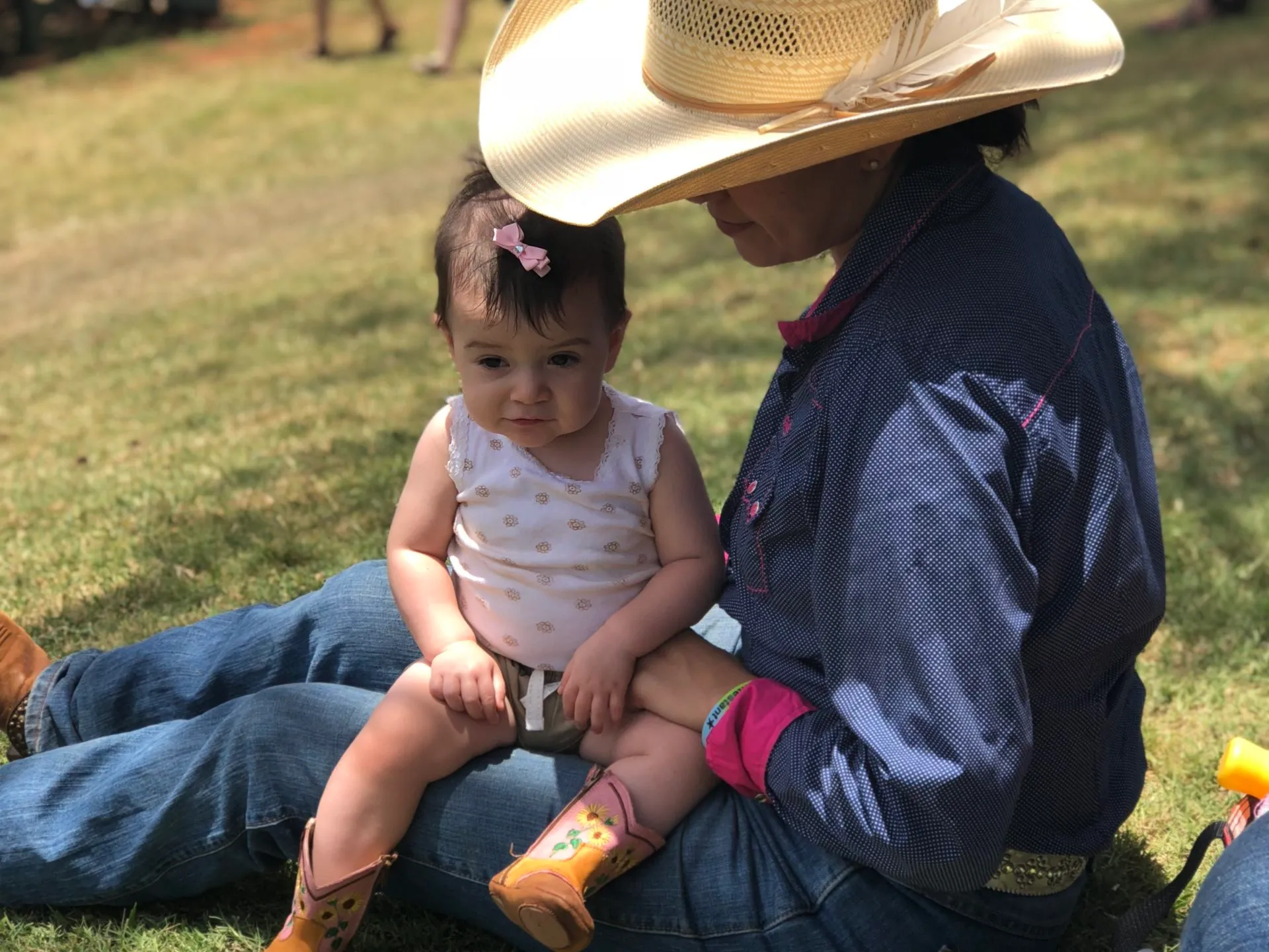 a little boy that is sitting in the grass