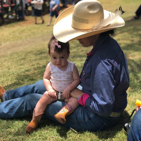 a little boy that is sitting in the grass
