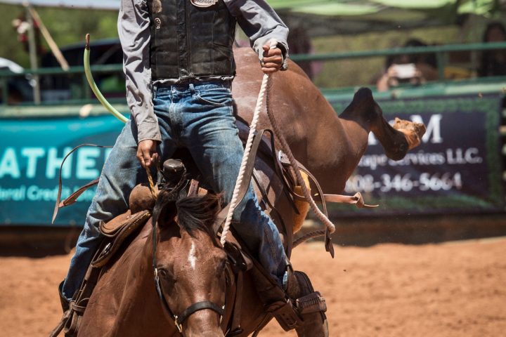 a man riding a horse in the dirt