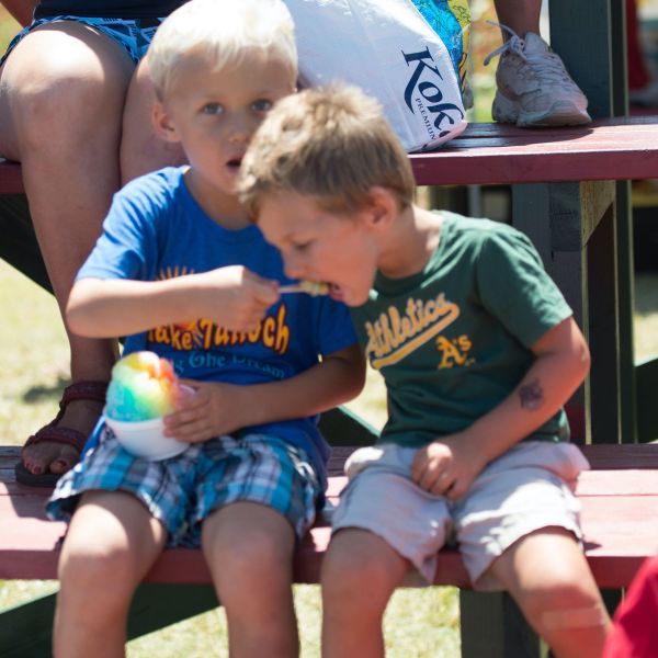 a group of young children sitting on a bench