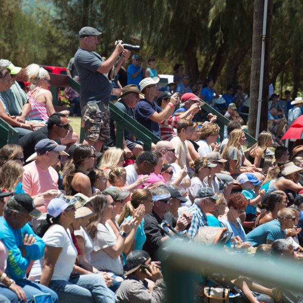 a group of people standing in front of a crowd